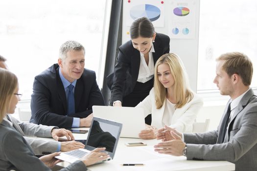 Meeting of business partners using laptops and talking at the table