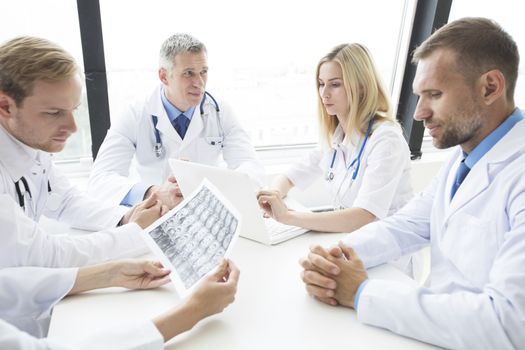 Team of doctors working in the office discussing brain MRI scan