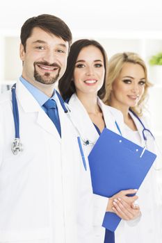 Portrait of confident happy group of doctors standing at the medical office