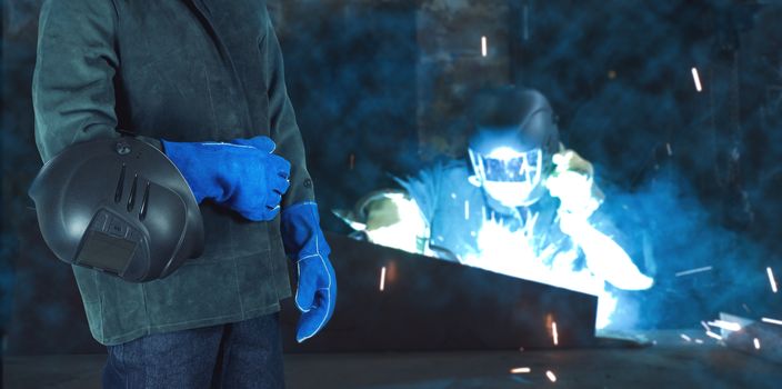 Welder in the workshop at the factory