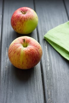 Ripe red apples on the black wooden background