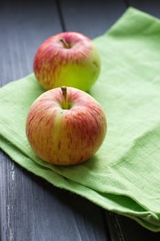 Ripe red apples on the black wooden background