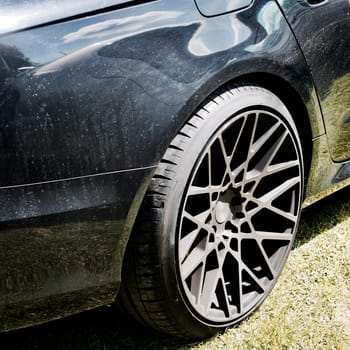 Black dirty car with nice big black wheels. Sport design car. Black body.