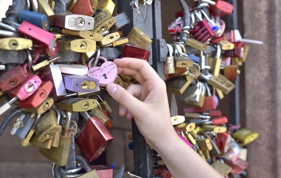 Girl hand on Love locks on Middle Rhine bridge- BASEL - Switzerland - 21 July 2017