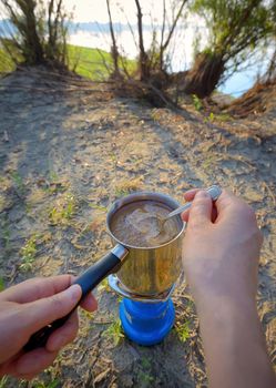 Making coffee on campfire in morning time