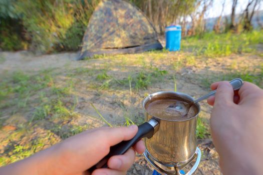 Making coffee on campfire in morning time