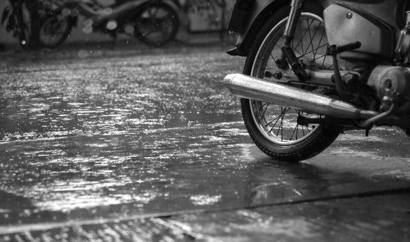 BLACK AND WHITE PHOTO OF MOTORCYCLE AND CLOSE-UP OF RAINDROPS