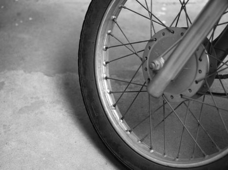 BLACK AND WHITE PHOTO OF CLOSE-UP OF MOTORCYCLE SPOKES AND WHEEL