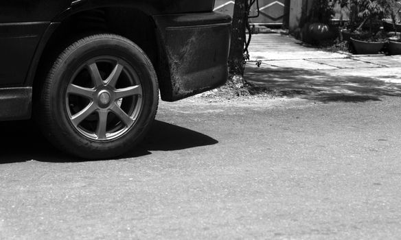 BLACK AND WHITE PHOTO OF CAR TYRE AND ALUMINIUM WHEEL RIM