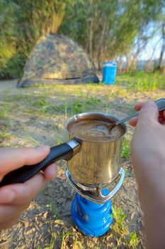 Making coffee on campfire in morning time