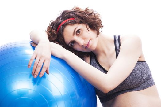 Young pregnant woman exercises with the ball.