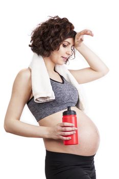 Young pregnant woman practicing fitness. Isolated on white background