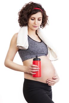 Young pregnant woman practicing fitness. Isolated on white background