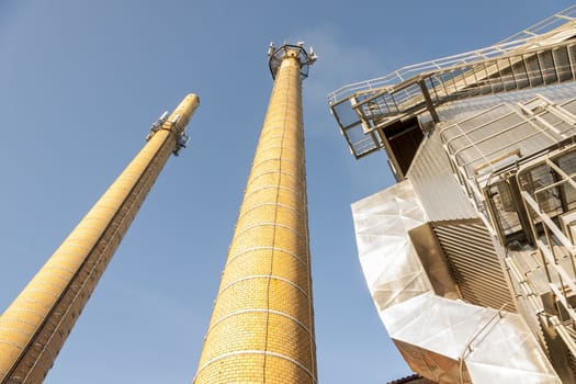 Two brick chimney  - blue sky.