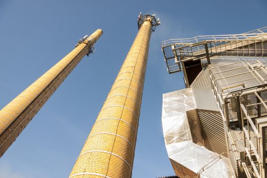 Two brick chimney  - blue sky.