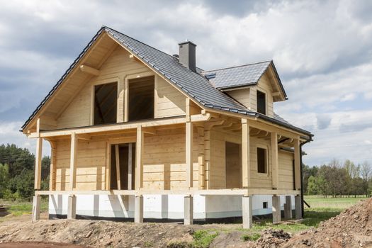 Wooden house with gray tiled roof - under construction.