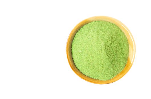 Closeup top view green matcha tea powder in bowl isolated on white background with clipping path