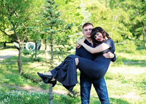 Madly happy girl and a guy in a city park.