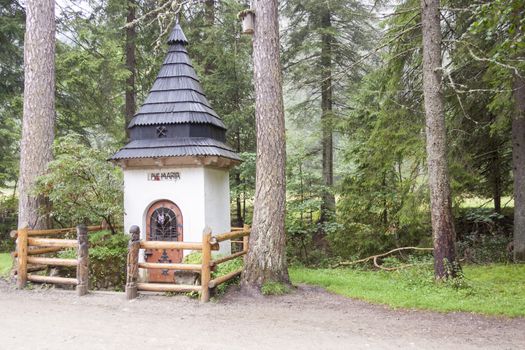 Small white shrine on trail in Koscieliska valley - Tatras National Park, Poland.
