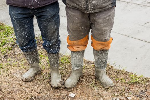 Two workers in wellingtons.