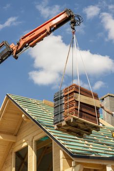 Roofer working on the top of the unfinished roof