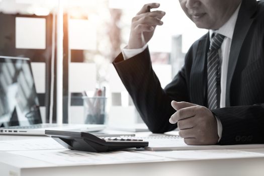 Businessman and calculator,Accounting conceptt vintage tone.