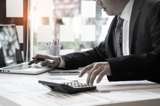 Businessman and calculator,Accounting conceptt vintage tone.