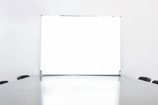 Closeup and soft focus of white empty board in conference room.