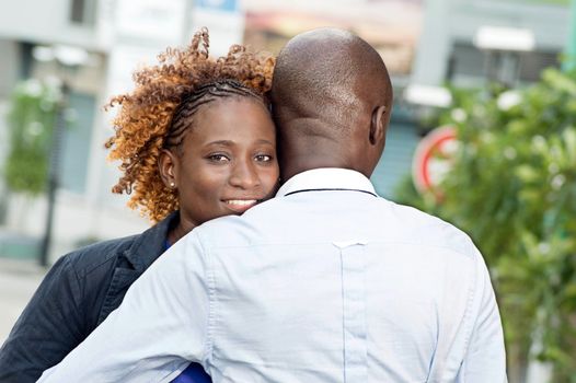 young couple embraces on the street and happy.
