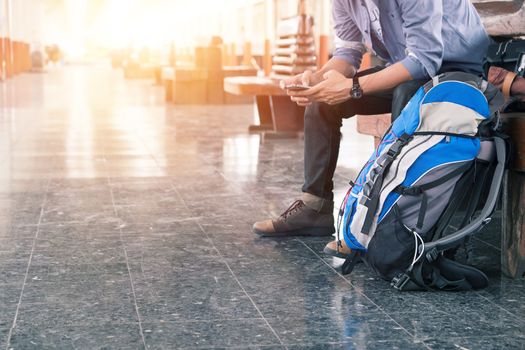 Backpacker at the train station with a traveler. Travel concept.