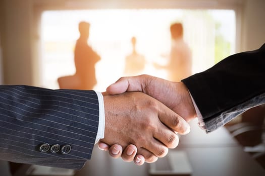  businessmen handshaking in a meeting room.acquisition concept with vintage tone.