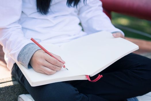 Kid writing on note paper.