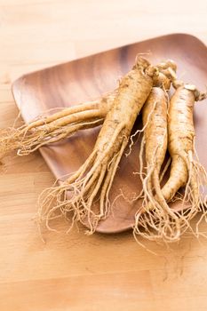 Ginseng over wooden background