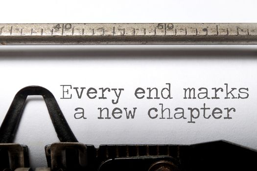 Every end marks a new chapter motivational saying printed on a typewriter 