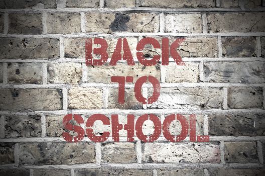 Back to school painted sign on a brick wall