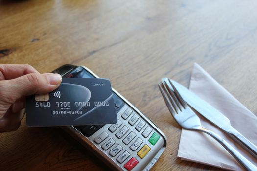 contactless payment card pdq background copy space with hand holding credit card ready to pay