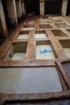 Tannery in the middle of souk in Fez, Morocco. Traditional leather tannery from the 11th century is now biggest tourits attraction in Fes.