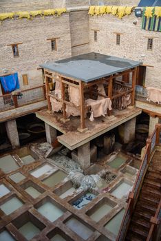 Tannery in the middle of souk in Fez, Morocco. Traditional leather tannery from the 11th century is now biggest tourits attraction in Fes.