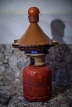 Traditional moroccan tajine making on gas bottle in the village