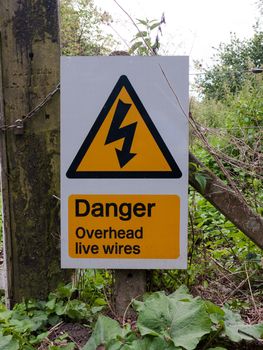 warning yellow triangle sign danger overhead live wires; UK