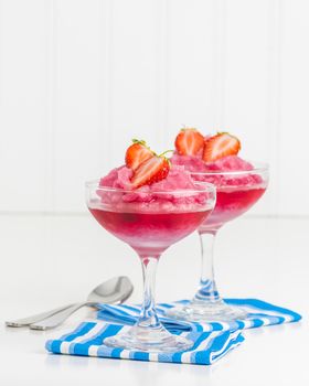 Homemade strawberry ice dessert garnished with fresh berries.  Ample copy space provided.