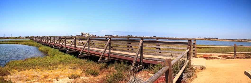 Bridge along the peaceful and tranquil marsh of Bolsa Chica wetlands in Huntington Beach, California, USA