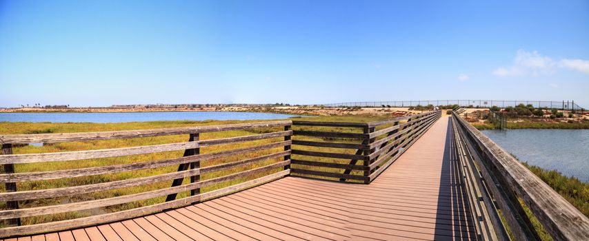 Bridge along the peaceful and tranquil marsh of Bolsa Chica wetlands in Huntington Beach, California, USA