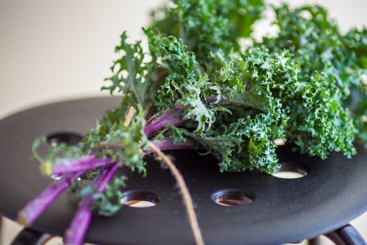 A bunch of fresh Kale salad on a wooden table