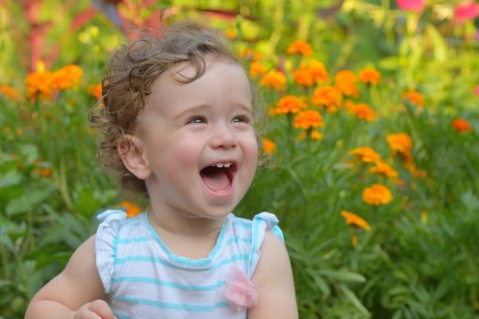 baby girl laughing in nature