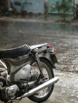 COLOR PHOTO OF MOTORCYCLE AND CLOSE-UP OF RAINDROPS