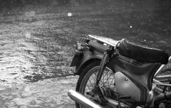BLACK AND WHITE PHOTO OF MOTORCYCLE AND CLOSE-UP OF RAINDROPS