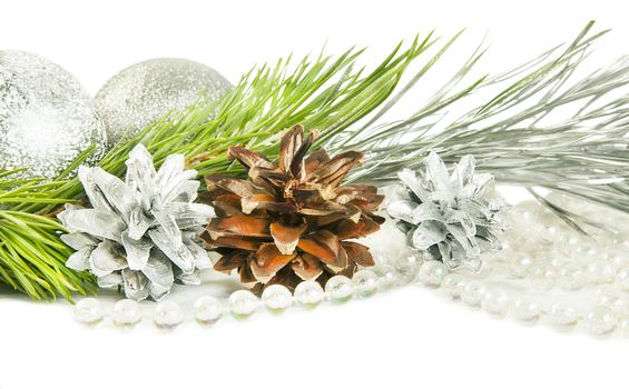 Fir tree branch and cones with silver ball isolated on white backround