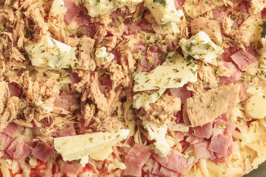 Pizza of ham, tuna and roquefort cheese