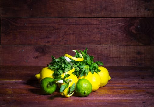 Citrus fruits, lemons and lime with mint on a wooden table